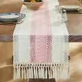 Rustic boho woven linen table runner featuring pink stripe and cream fringe tassels - Pink