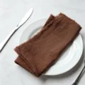 Dark brown fringed cotton napkin on white ceramic plate with cutlery - 32x32cm / Dark Brown