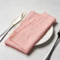 Elegant pink slub cotton fabric napkin with hemmed edges placed on a white dinner plate - 32x32cm (One Placemat) / Pink (CD260703-22)