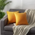 Two luxury yellow velvet pillowcases with decorative pom-pom trim shown on a sofa - 45x45cm (One Piece Without Core) / Orange