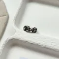 Macro detail view of a vintage openwork engraved ring featuring intricate floral patterns and stones - Hollow-out Geometric Floral Style (J7914) / Antique Silver