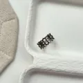 Macro view showing intricate hollowed floral patterns and vintage finish on Thai silver ring. - Hollow-out Symmetrical Engraved Style (J7926) / Antique Silver
