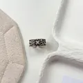 Detailed macro view of a vintage Thai silver floral open ring with crystal accents. - Hollow Woven Flower Style (J7904) / Adjustable Open / Antique Silver