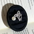 Close-up of elegant butterfly and pearl open ring displayed on a black velvet jewelry box. - Double Butterfly Style (No. 1) / Adjustable Open
