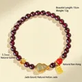 Natural garnet beaded bracelet with Hetian jade gourd charm and gold accents. - Gourd Style A / 5.5mm Bead Diameter / Burgundy