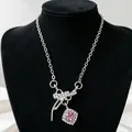 Detail view of a silver bow necklace featuring a radiant pink square zircon pendant. - Pink Rhinestone