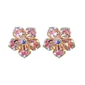 Close-up detail of exquisite pink petal zircon flower stud earrings with a blue center stone - Pink