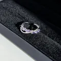 Macro view of elegant purple gemstone criss-cross ring in a black velvet jewelry box - No. 5 Open Ring (Purple Marquise)