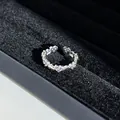 Close-up of a silver ring with purple heart-shaped rhinestones in a black velvet box. - No. 6 Open Ring (Purple Heart)