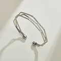 Close-up detail of the three-layer minimalist geometric silver-tone open cuff bracelet - Three-Layer Irregular Geometric Style / Silver