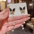 Elegant black butterfly dangle earrings with long gold tassels and white pearls - Black Butterfly Tassel Style (E2995) / Gold