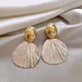 Elegant vintage gold-tone fan-shaped drop earrings for women on silk background - Fan Shell Texture Earring Style (E3267) / Gold and Silver
