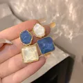 Detail of asymmetric geometric earrings with blue and white water ripple texture - Geometric Blue White Patchwork Style (E3030) / Gold Blue