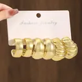 Close-up view of a multi-style golden earring set including smooth and ribbed designs - Fashion Style (TZ020)