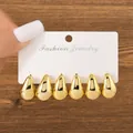 Detailed view of three pairs of shiny gold waterdrop earrings on a white display card - Triple Water Drop Earring Set (TZ015) / 3 Pairs Set