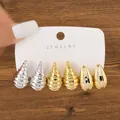 Detailed view of three-pair fashion earring set with metallic seashell and drop shapes. - Shell Spiral Two-Tone Set (TZ009) / 3 Pairs Set