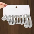 Detailed view showing three pairs of silver fashion earrings on a display card - Minimalist Hoop Collection (TZ059) / 3 Pairs Set / Silver