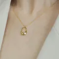 Close-up view of a minimalist irregular gold pendant necklace worn by a fashion model - Gold Irregular Ring Style (XL1533)