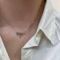 Detail of a minimalist 925 sterling silver lava drip pendant necklace on a neck. - Molten Droplet Style (XL1684)