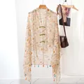 Vintage floral ethnic style shawl featuring frog buttons and elegant tassel hem details - Calendula
