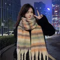 Soft mohair-like striped scarf with thick tassels worn by a model in an urban setting - 40x230cm / Mohair Striped Beige