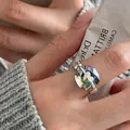 Close-up of geometric iridescent crystal ring with silver heart detail on finger. - Heart Square Stone (J3126)