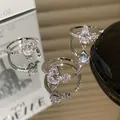 Macro detail of silver rings with marquise-cut sparkling stones on a mirror surface - Marquise Stone Style (J3150)