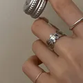 Close-up detail of a vintage silver gingerbread man ring worn on a model's finger. - Vintage Silver (J3279)