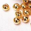Macro detail showing shiny gold-plated CCB round beads with straight holes for DIY - 6mm / Imitation Gold
