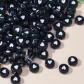 Dettaglio di perle acriliche nere da 7 mm con cuori bianchi per creazione gioielli DIY. - 4mm x 7mm, 4000 Pezzi / Bianco e Nero