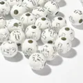 Macro detail of 8mm white acrylic beads featuring silver engraved cross patterns for DIY crafts - 1800 Pieces/Pack / Silver Wire White