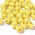 Macro detail of 8mm yellow acrylic round beads with silver cross patterns for DIY crafts - 1800 Pieces/Pack / Silver Line Light Yellow