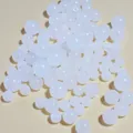 Close-up macro view of mixed size white acrylic jelly beads for DIY jewelry making crafts - 6mm / White