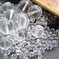 Macro view of transparent acrylic beads showing high clarity and threading holes - 6mm (500g/Pack) / Clear White