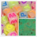 Close-up of 6mm acrylic alphabet beads with glow-in-the-dark effect for DIY crafts - Luminous Colorful Letters
