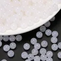Detailed view of white translucent acrylic jelly round beads for DIY jewelry beading - 6mm / Jelly White