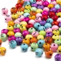 Detail macro shot of 8mm colorful round acrylic beads with black alphabet letters. - 8mm (Approx. 1800 Pcs/Pack) / Colorful with Black Letters