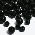 Close-up of glossy black acrylic round beads with straight holes for DIY crafting - 4mm / Black