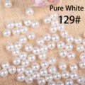 Close-up detail of white round acrylic pearls for DIY jewelry making accessories. - 8mm / Pure White Artificial Pearl