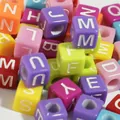 Macro shot of 6mm colorful acrylic alphabet square beads for DIY craft jewelry making. - Colorful Base with White Letters