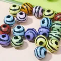 Detailed view of colorful round acrylic beads featuring black zebra stripe patterns - 520 Pieces/Pack / 12mm / Multicolor