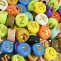 Macro view of 7mm colorful acrylic beads with golden engraved letters for DIY jewelry crafts - 4000 Pieces/Pack / Colorful Base with Gold Letters