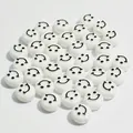 Close-up of 10mm white acrylic flat round beads with black smiley face pattern - Smiley Face (6x10 mm Round Smiley Face) / 1600 Count / White Base Black Line