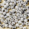 Macro detail of 8mm white acrylic beads with black splatter imitation ceramic effect - 8mm (Approx 1800 Pcs/Pack) / White
