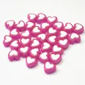 Close-up of glossy pink acrylic heart beads featuring white centers for DIY crafting - Heart Shape / 500g Pack / Rose Red