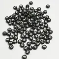Detail shot of black acrylic round beads with white numbers for DIY jewelry making - 4000 Pieces/Pack / Black Base White Line