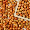 Detailed macro view of 8mm orange acrylic crackle beads with ceramic spray-point texture. - 500g/8mm/1800 Pieces/Pack / Orange