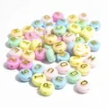 Close-up of 10mm macaron acrylic alphabet beads with gold letters for DIY jewelry making. - 1600 Pieces (6x10mm) / Light Color Base Gold Letters