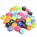 Close-up view of 10mm colorful acrylic round flat alphabet beads for DIY jewelry - 1600 Pieces (6x10mm) / Multicolor with Silver Cross