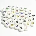 Detailed view of 10mm white acrylic round flat beads with colored alphabet letters - 1600 Pieces (6x10mm) / White Base Colorful Letter